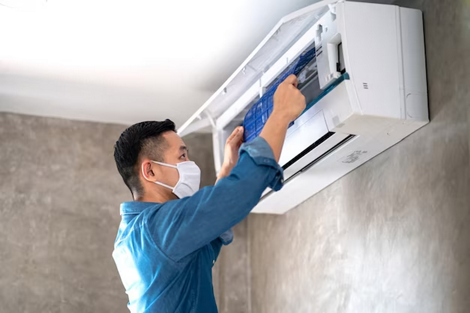 Man cleaning a split-type air conditioner